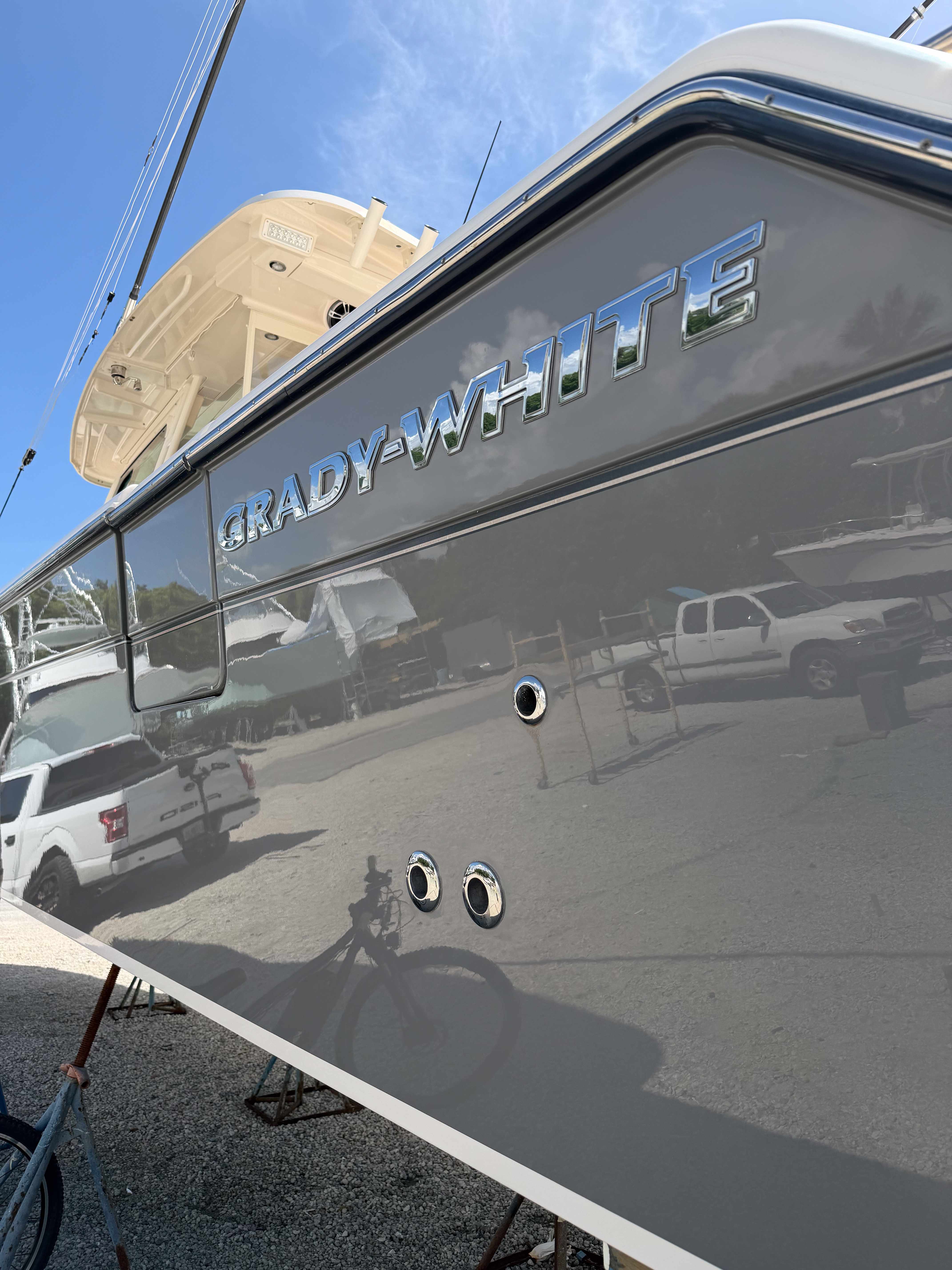 Boat hull and service stands in an outdoor marine yard