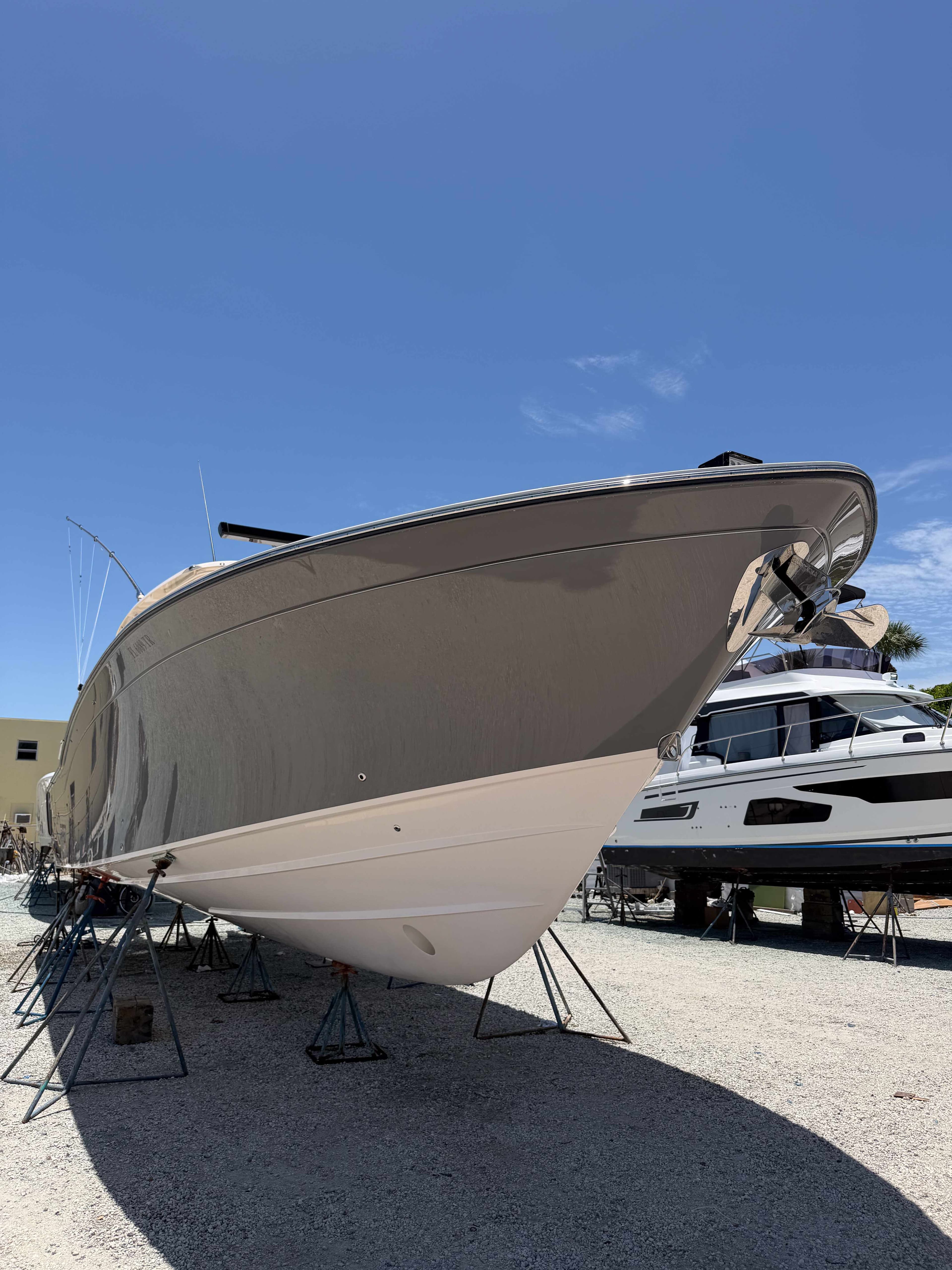 Boat hull supported on stands in a service yard