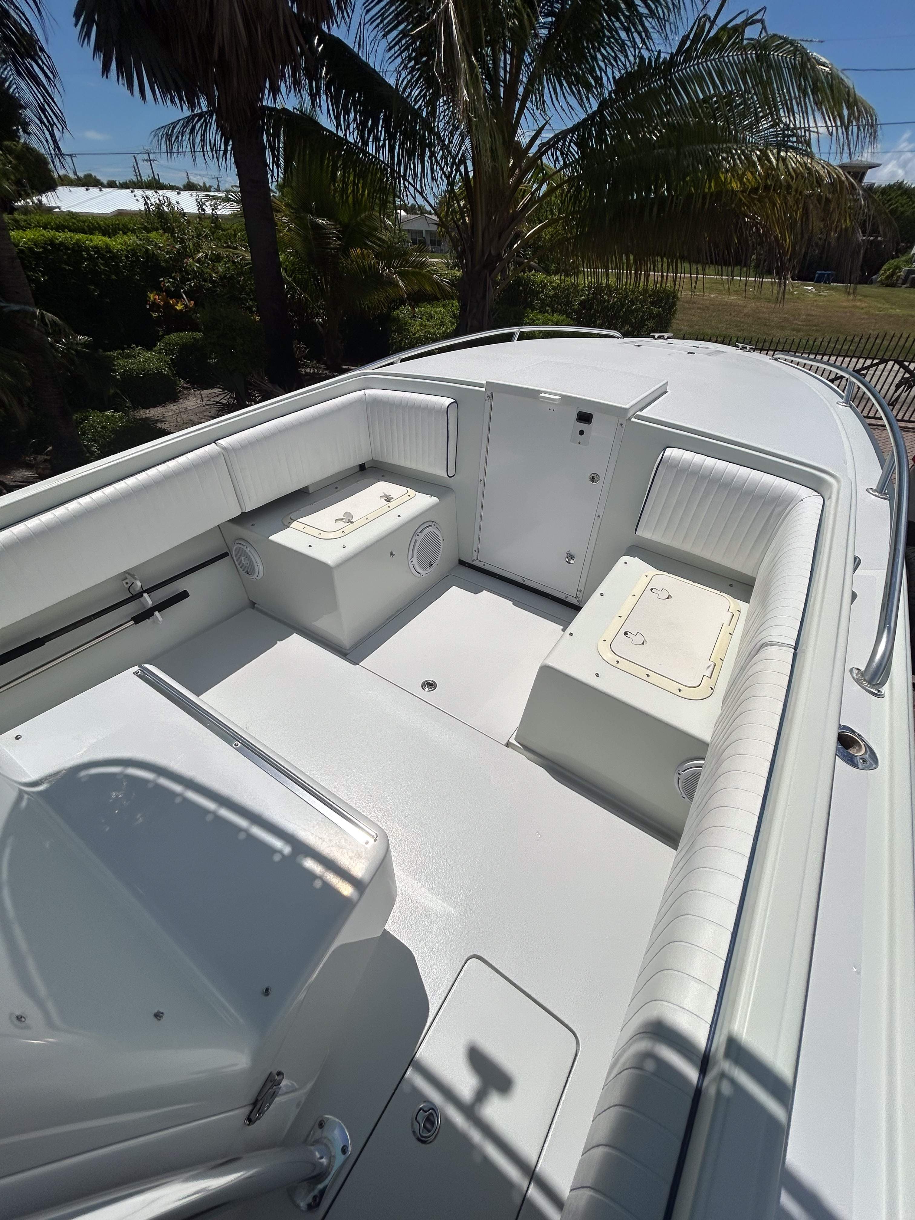 Yacht deck and helm area with white upholstery and blue accents