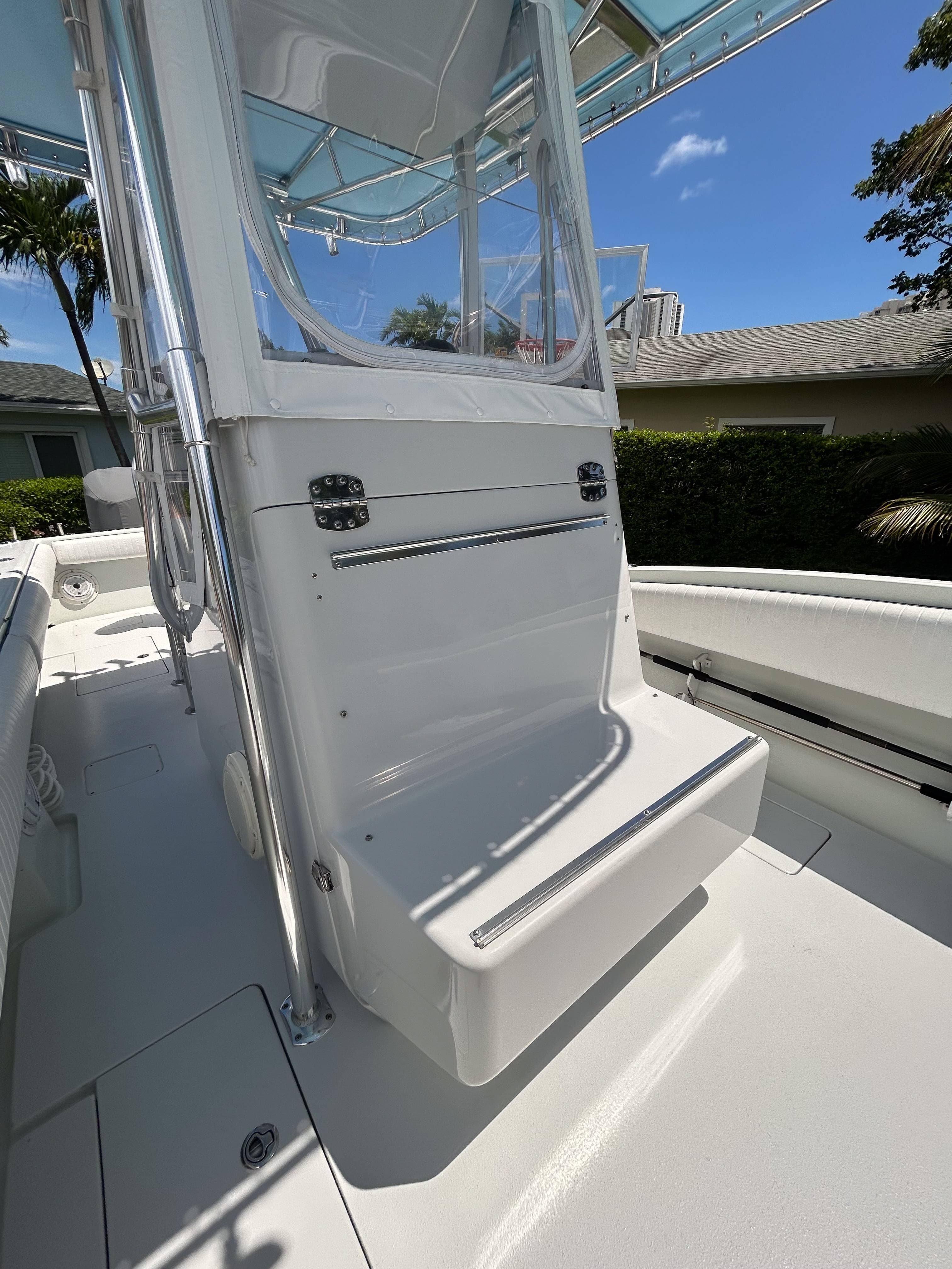 Yacht helm and polished windshield viewed from the cockpit